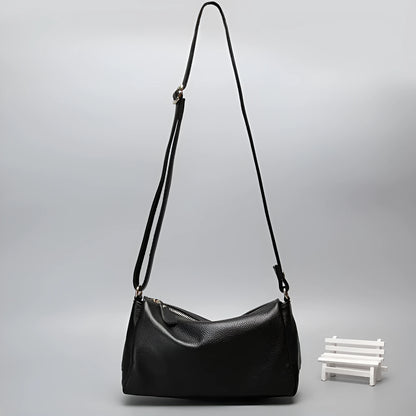 Soft genuine leather women's crossbody bag in horizontal square shape with single shoulder strap.