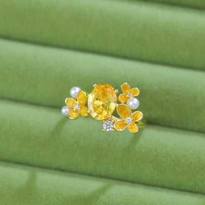 Adjustable open ring with flower design featuring pearl and zircon elements in yellow or light purple finish