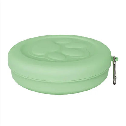 Collapsible silicone dog bowl with integrated snack compartment in light pink colour