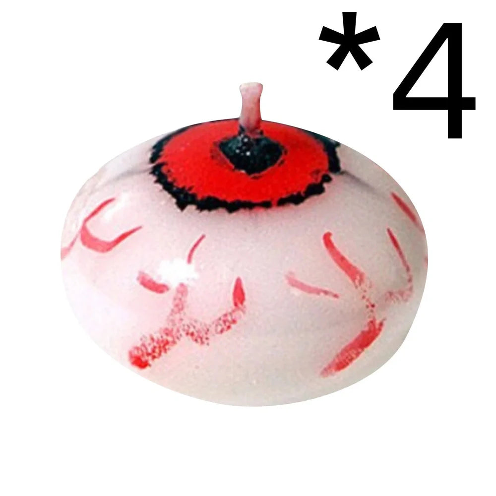 Red oval paraffin floating candle resembling eyeball in Halloween water display