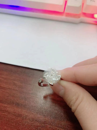 Gold-toned geometric ring with a central spinning windmill detail on a person's finger.