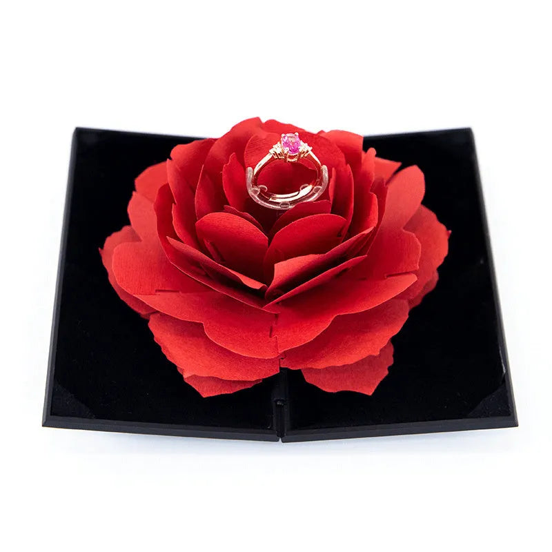 Red 3D heart-shaped plastic ring box with rose decoration on a rotating stand