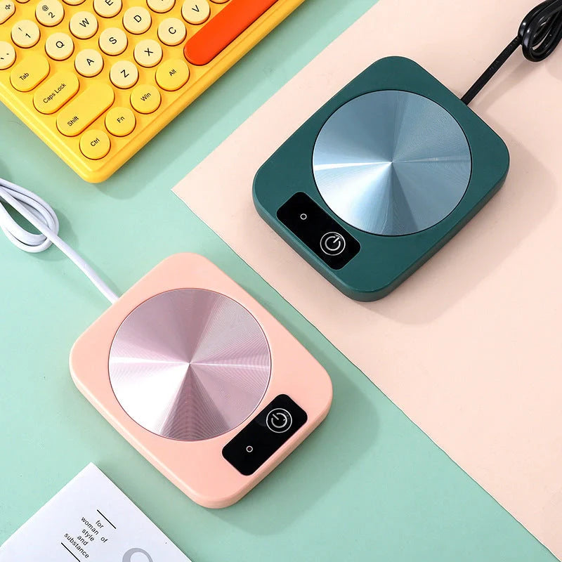 Electric tea water heating pad on desk with coffee cup, keeping beverage warm