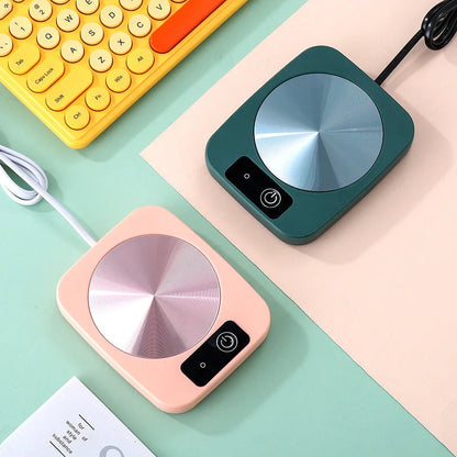 Electric tea water heating pad on desk with coffee cup, keeping beverage warm