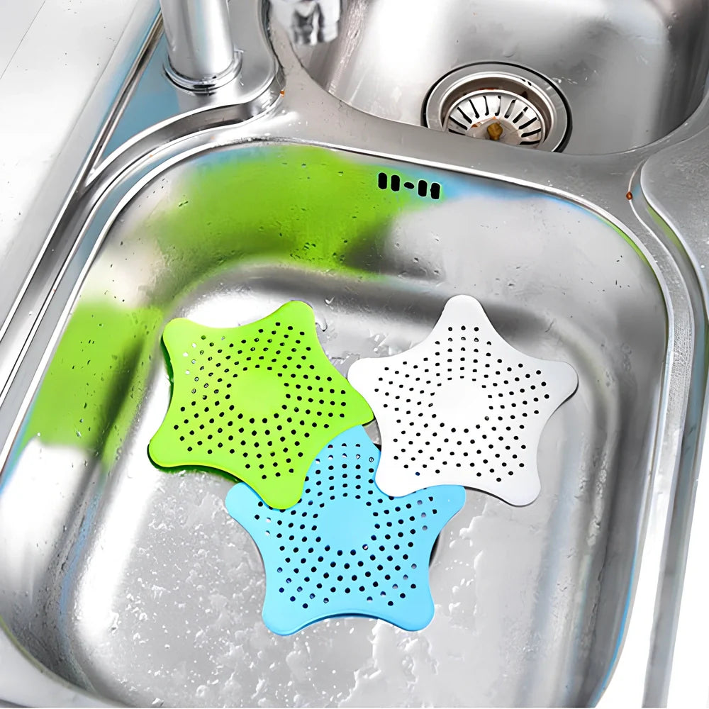 Three starfish-shaped sink drain filters in white, blue and green colours showing suction cups on bottom