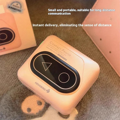 Compact Avocado Green mini Bluetooth thermal printer with mobile phone, thermal paper roll, and charging cable.