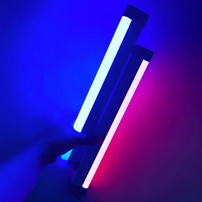 Blue rechargeable LED light tube with USB plug and push-button switch on a dark surface
