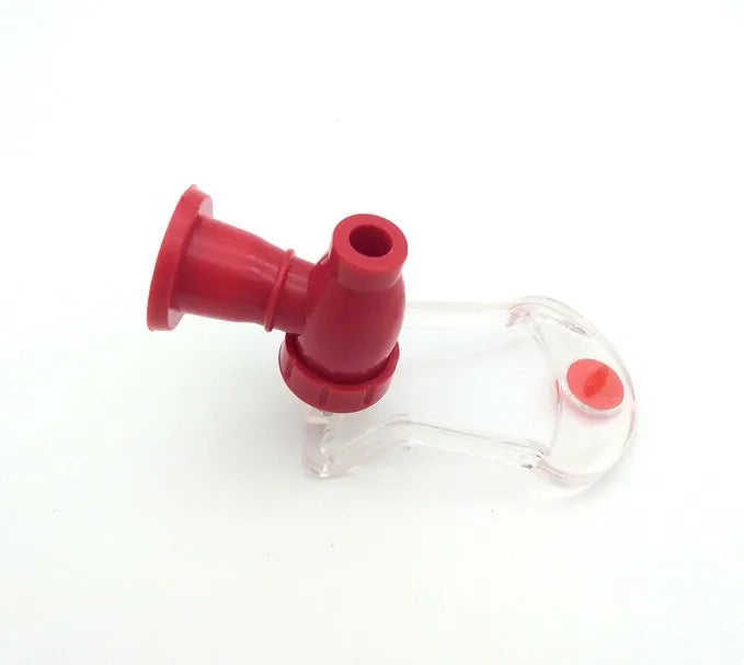 Red plastic soda dispenser attached to inverted 2-litre bottle with push-button mechanism