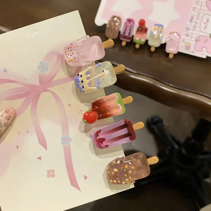 A resin hair barrette with a cartoon ice cream charm on a side-clip, shown in a pink colour variant.