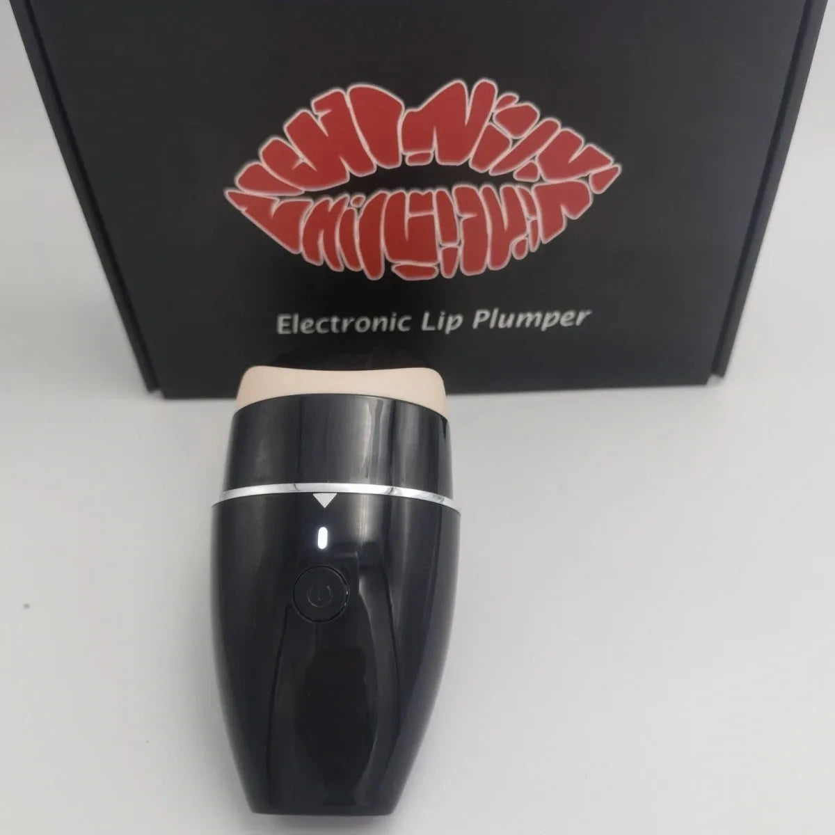 Black and white electric lip plumper device with silicone tip and USB cable