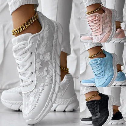 Women's canvas sports shoes in white with round toe and flat heel design on a light background