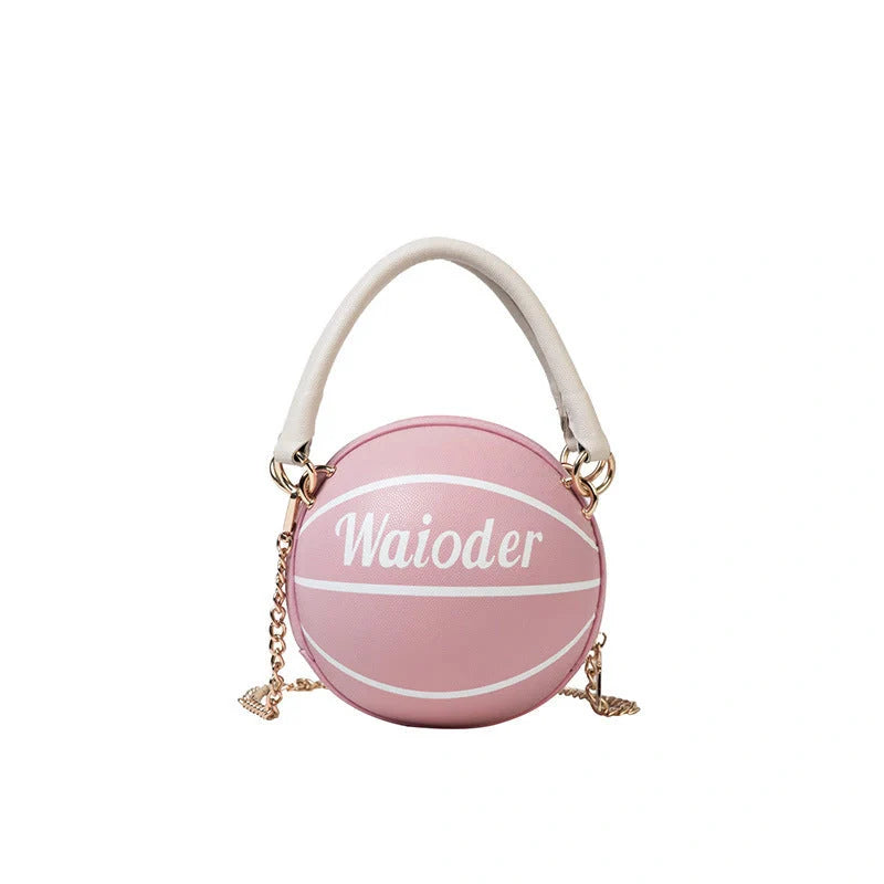 Basketball-shaped handbag with adjustable shoulder strap in pink, white, black, and brown