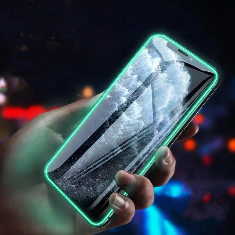Luminous tempered glass screen protector glowing in dark next to iPhone