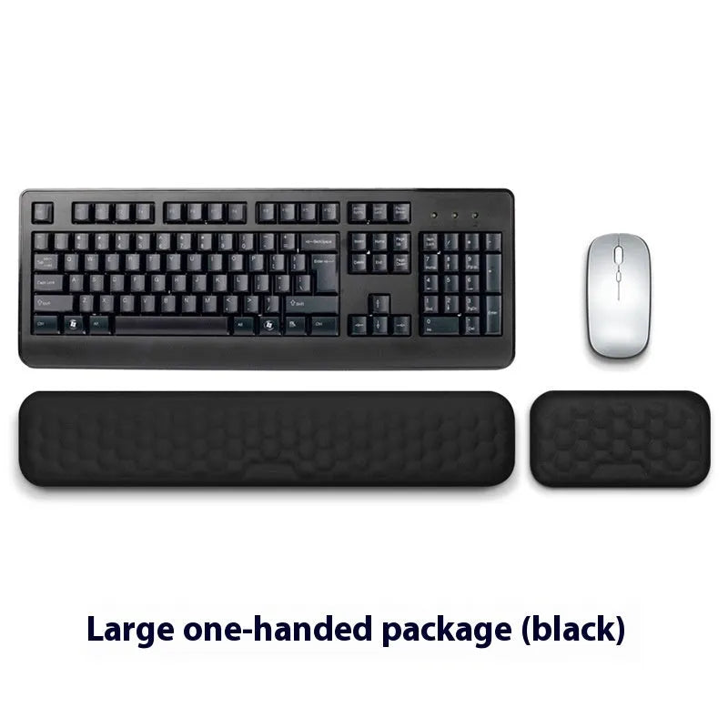 Black and grey memory foam mouse wrist rests with cloth and leather-style covers on a desk.