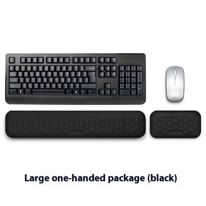 Black and grey memory foam mouse wrist rests with cloth and leather-style covers on a desk.