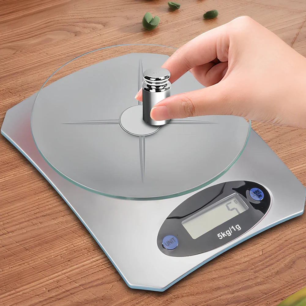 Silver white mini electronic kitchen scale with digital display showing 0.1g precision measurements