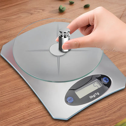 Silver white mini electronic kitchen scale with digital display showing 0.1g precision measurements