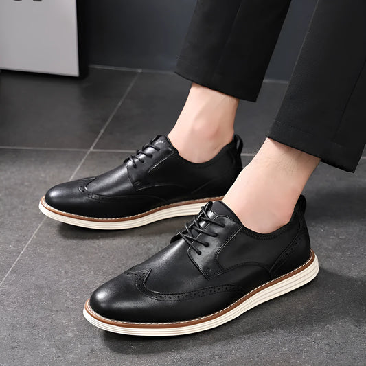 Men's black and brown slip-on business casual shoes with round toe and carved PU upper.