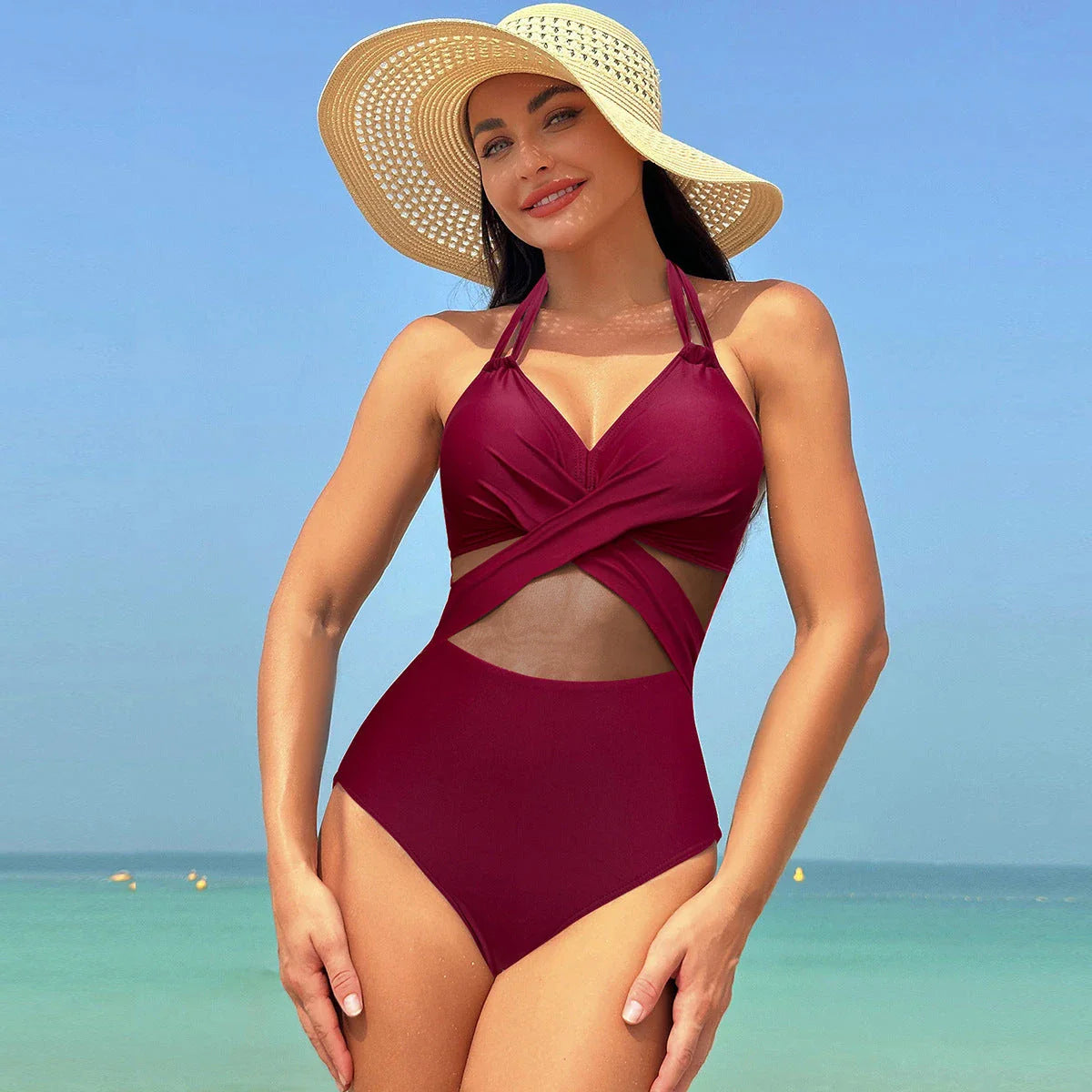 Halter one-piece swimsuit with cross-strap design, available in various solid colors and leopard print