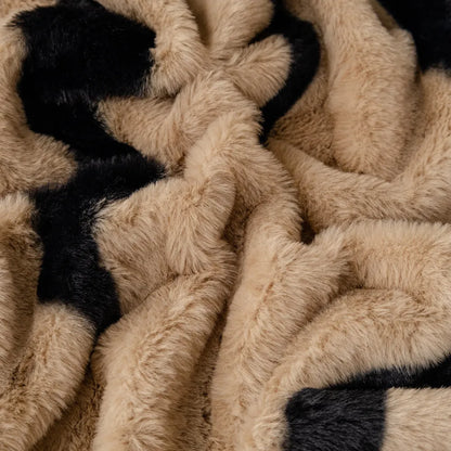 Zebra pattern sofa cover cloth in flannel fabric with non-slip backing, shown in caramel colour on a sofa