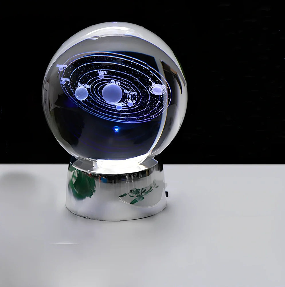 Solar system crystal ball showing planets inside K9 optical crystal sphere on metallic base