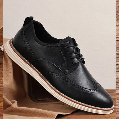 Men's black and brown slip-on business casual shoes with round toe and carved PU upper.