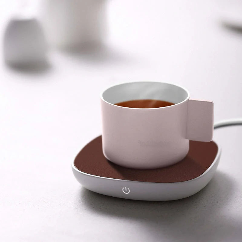 White 12V safety voltage heated base heating coaster on a wooden table