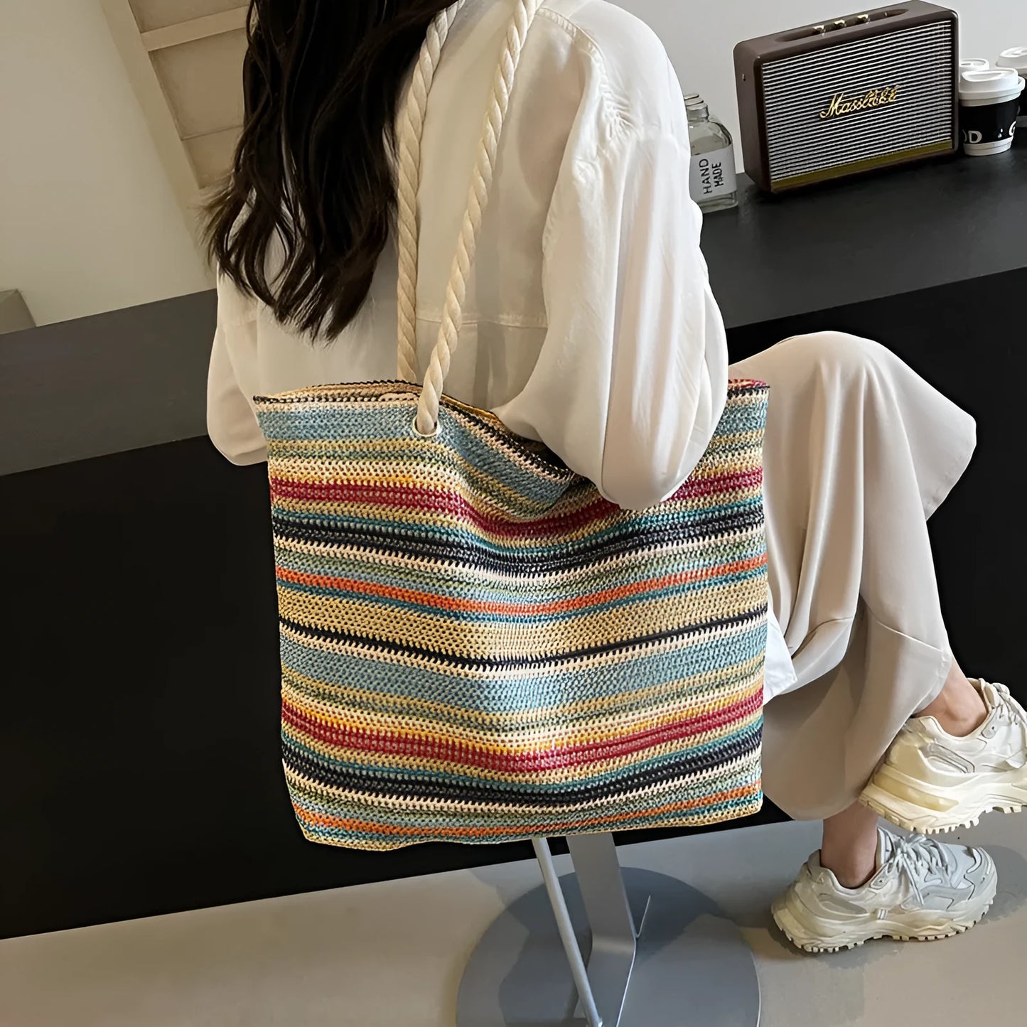 Blue straw-woven nylon shoulder bag with a single strap and large compartment.