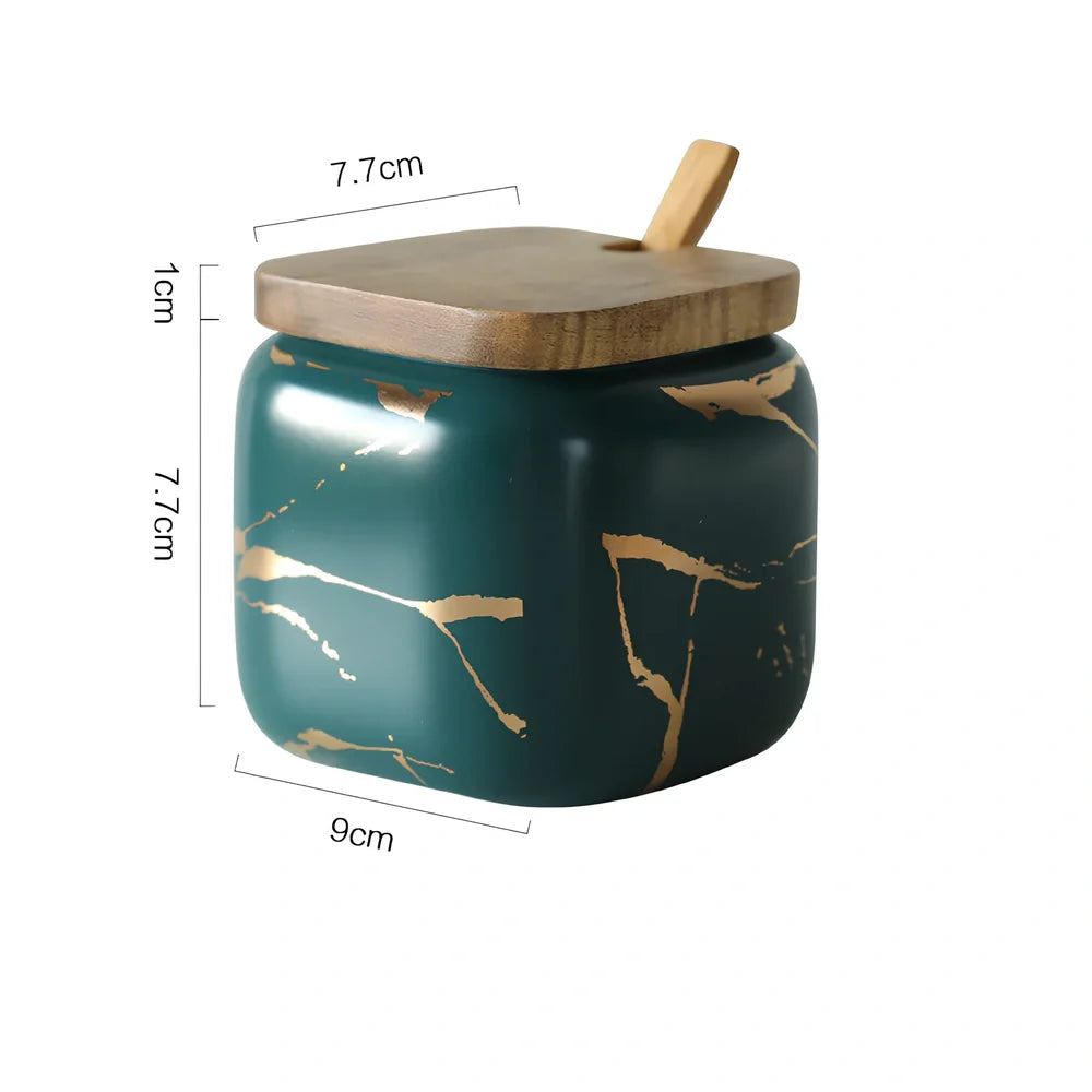 Three-piece Nordic Gold Marble Jar Set in white ceramic with wooden tray and bamboo spoons on kitchen counter