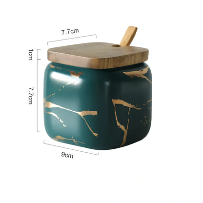 Three-piece Nordic Gold Marble Jar Set in white ceramic with wooden tray and bamboo spoons on kitchen counter