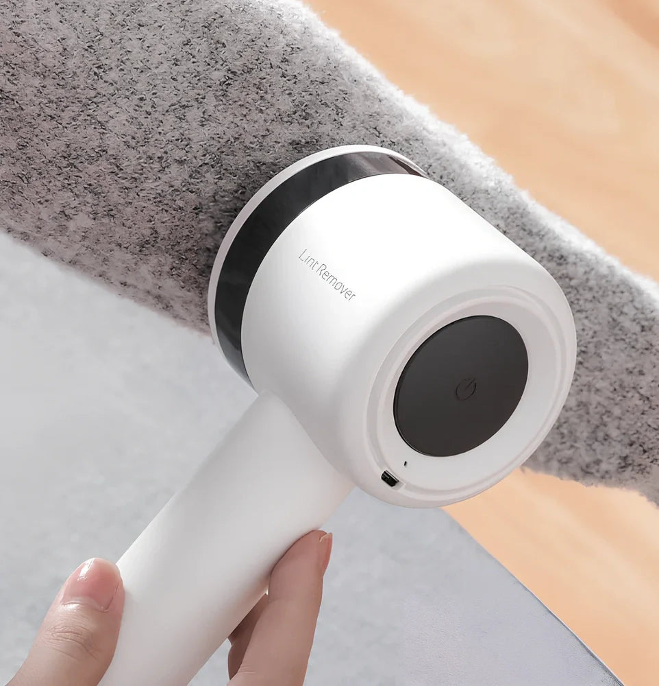 White rechargeable lint remover with detachable head and USB charging cable