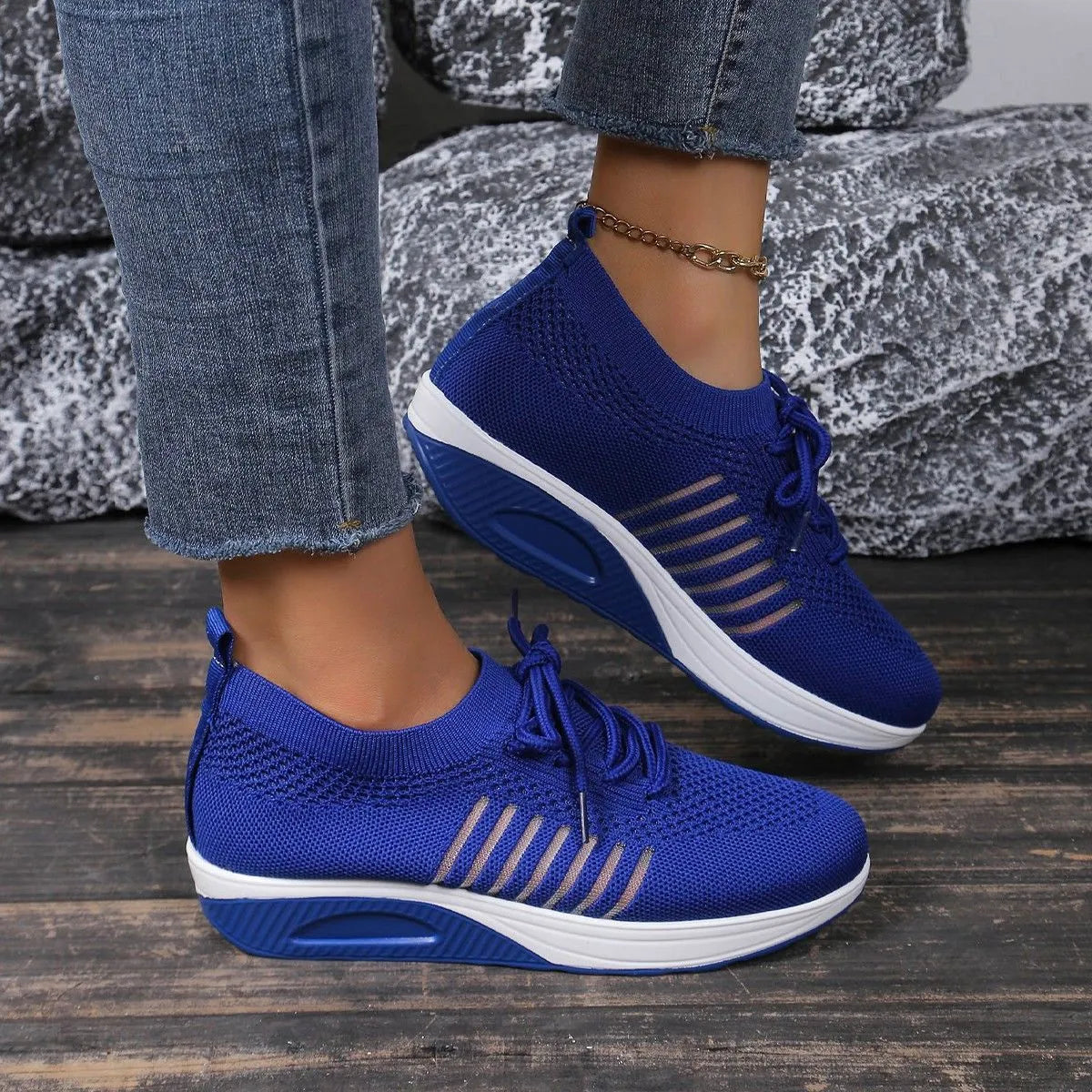 Women's red platform sneakers with mesh upper and front lace-up design on rubber sole