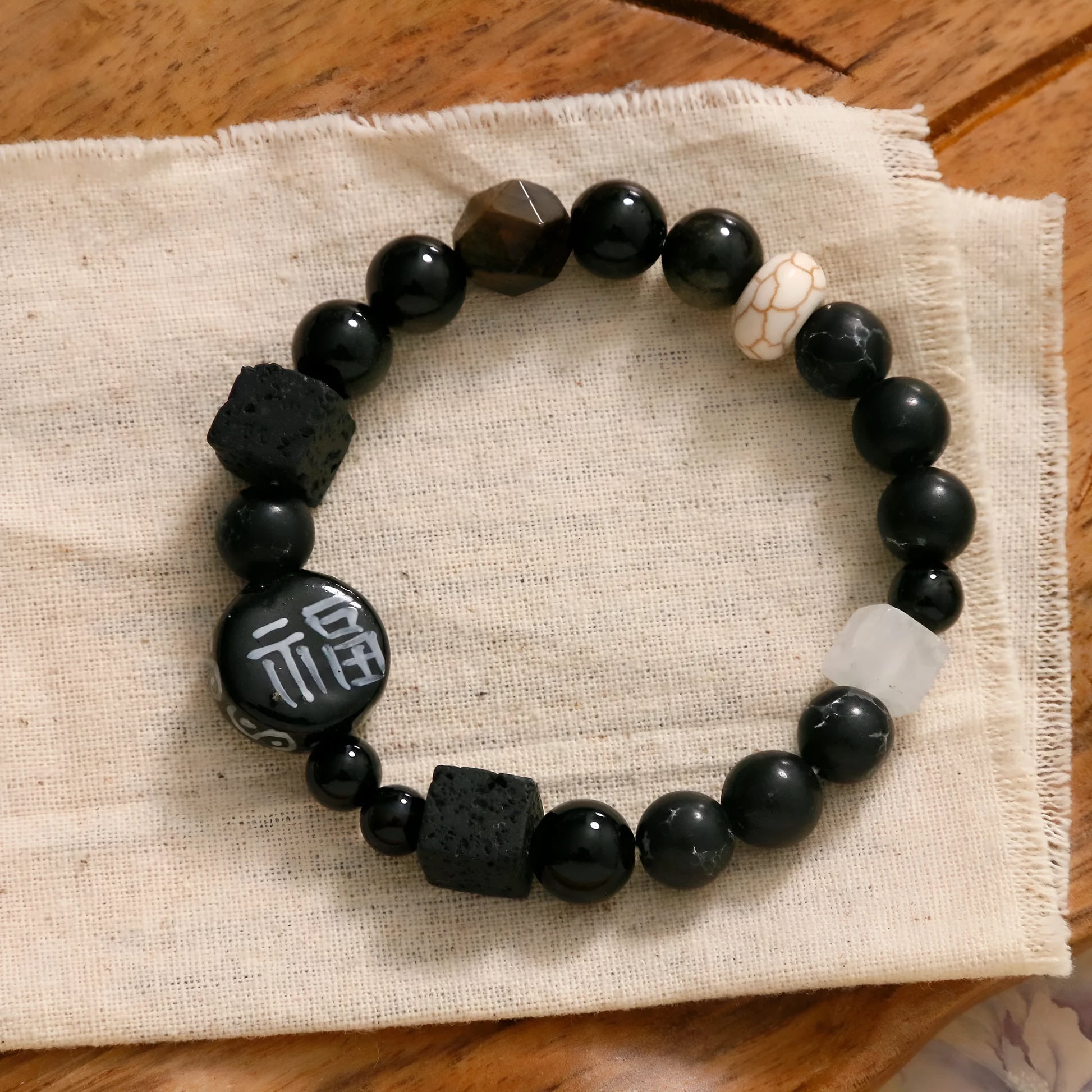 Hand-woven natural black agate ceramic bracelet with geometric design and round elements
