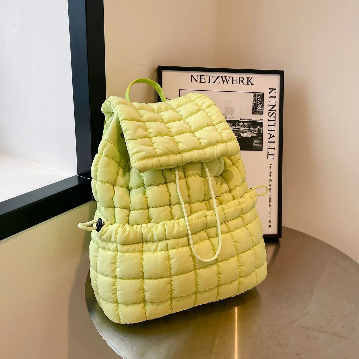Soft, quilted puffer backpack in a variety of colors, perfect for autumn and winter wear