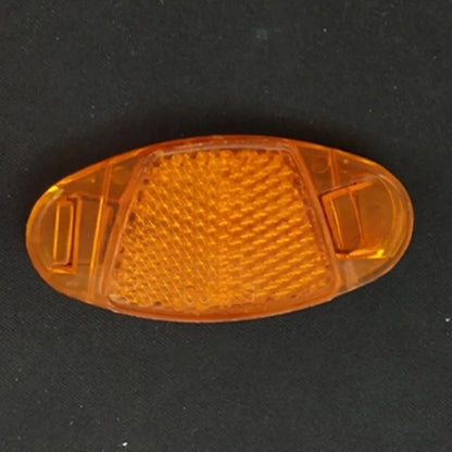 Four white bicycle spoke reflectors showing dimensions of 7.2cm by 3.5cm