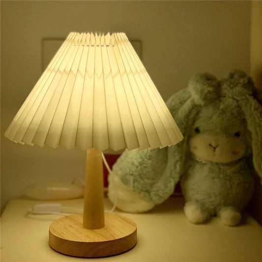 Vintage-inspired desk lamp with a pleated fabric shade, bamboo base, and touch-sensitive dimming controls