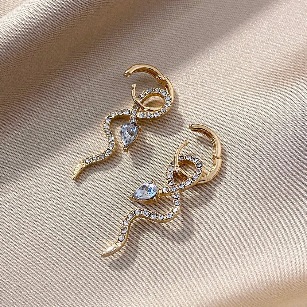 Pair of golden snake-inspired dangle earrings with a captivating and elegant design