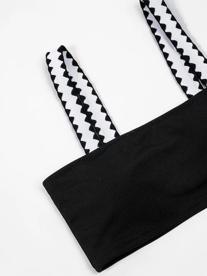 Black hollowed-out split briefs swimsuit for women made from polyester fabric
