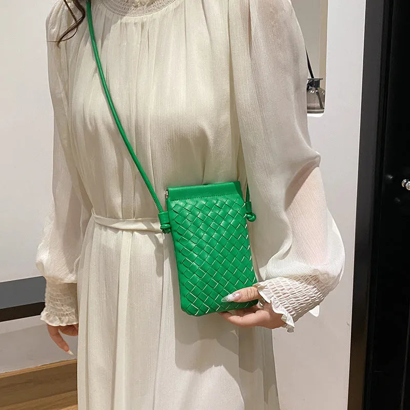 Vertical square vintage weave crossbody bag in multiple colours showing internal dark cell phone pocket.