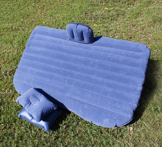 Black inflatable car bed with flocked surface shown in five-seater vehicle, folded chair configuration displayed alongside