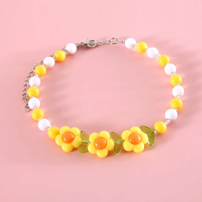Colourful plastic bead cat necklace with adjustable clasp showing peach, rainbow, and small flower pattern options