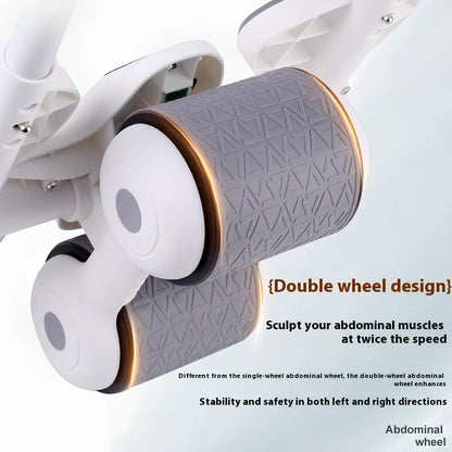 Black abdominal exercise wheel with four elbow support pads on grey floor