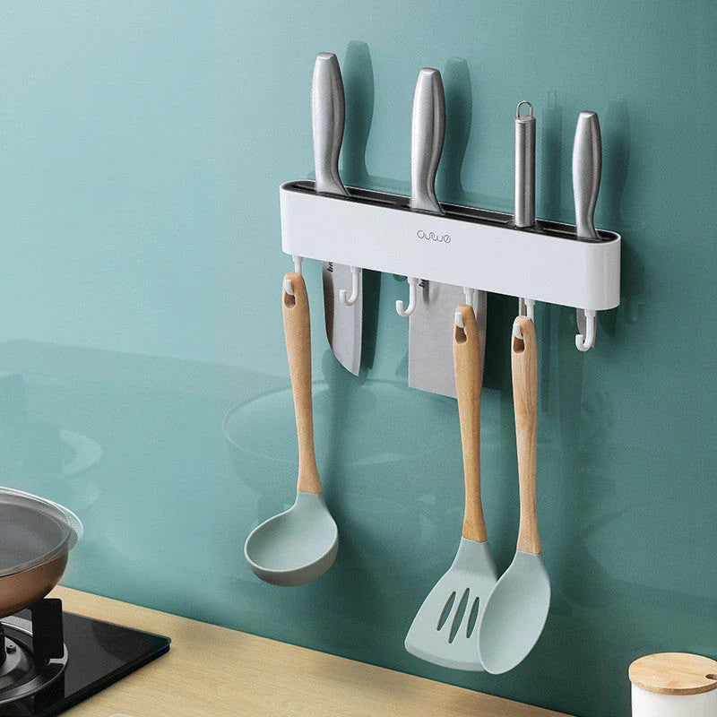 Sleek wall-mounted knife organizer with slots for knives and hooks for storing kitchen essentials
