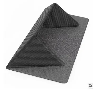 Blue or grey foldable laptop cooling stand with anti-slip surface on a desk.