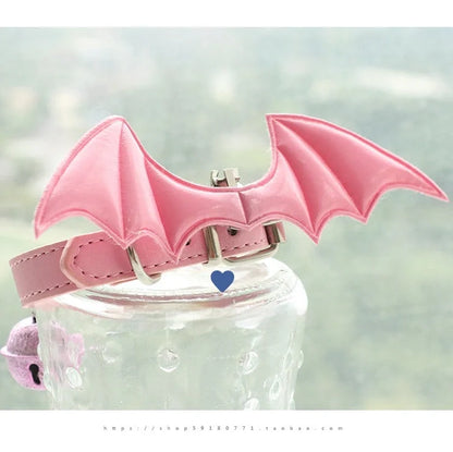 Black patent leather choker with 15cm wings decoration and bell attachment on adjustable 30-40cm collar