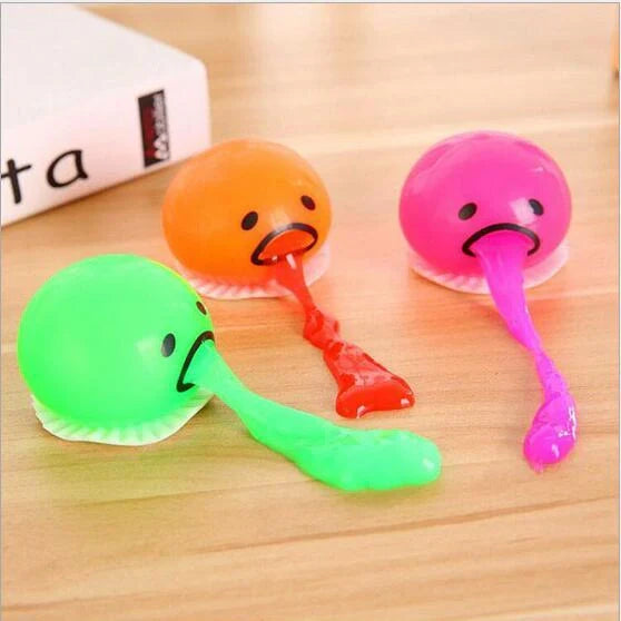 Gudetama Vomiting Egg Toy in green, orange, pink, and yellow for stress relief and fun