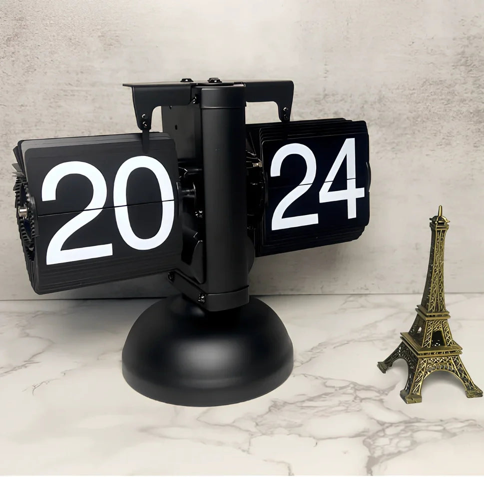 Black and white flip digital clock showing 12:34 with retro flip digits on wooden table