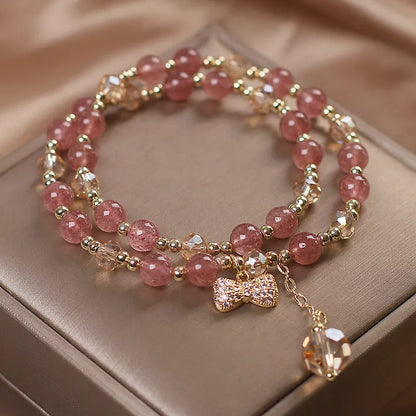 Double-layer strawberry quartz crystal bracelet with lucky cat charm and red cat's eye flowers design.