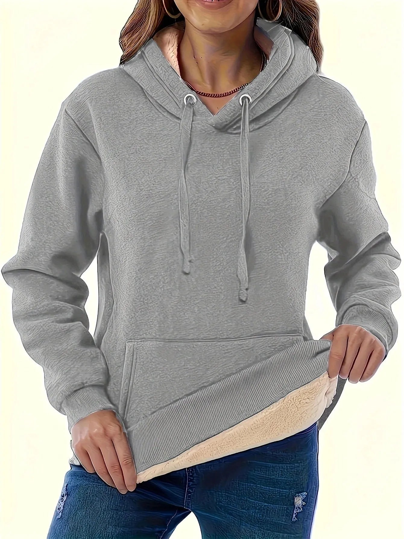 Women's loose fit hooded sweater in thick grey polyester fleece with 3D pattern and front pockets.