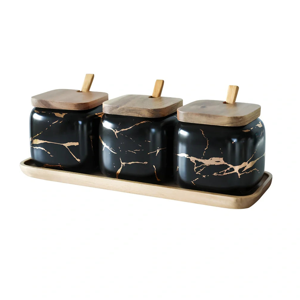 Three-piece Nordic Gold Marble Jar Set in white ceramic with wooden tray and bamboo spoons on kitchen counter